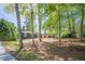 A beautiful home sits on a wooded lot with a long driveway at 3350 Pine Meadow Nw Rd, Atlanta, GA 30327