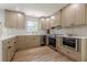 A well-designed kitchen featuring stainless steel appliances, wood floors, and light-colored custom cabinets at 3350 Pine Meadow Nw Rd, Atlanta, GA 30327