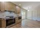 Modern kitchen with stainless steel appliances, light-colored cabinets and adjacent dining area at 3350 Pine Meadow Nw Rd, Atlanta, GA 30327