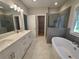 Elegant bathroom with soaking tub, glass shower and white double sink vanity at 2071 Westside Blvd, Atlanta, GA 30318