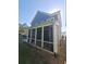 Exterior side view of the home showing the screened in porch that allows for relaxed outdoor living at 2071 Westside Blvd, Atlanta, GA 30318