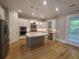 Modern kitchen featuring white cabinets, stainless steel appliances, and a granite island at 2071 Westside Blvd, Atlanta, GA 30318