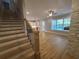 Hardwood stairs lead to an open living area with a kitchen and stone fireplace at 2071 Westside Blvd, Atlanta, GA 30318