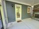 View of the screened porch with a door, window, and brick fireplace, creating a cozy outdoor living space at 2071 Westside Blvd, Atlanta, GA 30318