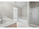Bright bathroom with double sinks, soaking tub, and glass-enclosed shower at 2602 Avery Park Cir, Atlanta, GA 30360