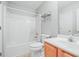 Cozy bathroom with a tub and shower combo, wood vanity, and tiled floor at 2602 Avery Park Cir, Atlanta, GA 30360