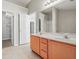 Bright bathroom with a double sink vanity, large mirror, and access to a closet and a shower at 2602 Avery Park Cir, Atlanta, GA 30360