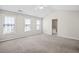Spacious bedroom featuring a vaulted ceiling, plush carpet, and natural light from multiple windows at 2602 Avery Park Cir, Atlanta, GA 30360