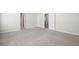 Carpeted bedroom featuring neutral walls, and an open doorway, offering a comfortable and relaxing space at 2602 Avery Park Cir, Atlanta, GA 30360