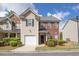 Charming townhome showcasing brick and siding exterior, attached garage, and well-maintained landscaping at 2602 Avery Park Cir, Atlanta, GA 30360