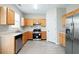 Well-lit kitchen features stainless steel appliances, wood cabinets, and laminate countertops at 2602 Avery Park Cir, Atlanta, GA 30360