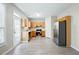 Eat-in kitchen featuring stainless steel appliances, wood cabinets, and gray, waterproof plank flooring at 2602 Avery Park Cir, Atlanta, GA 30360