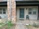 Cozy front porch featuring neutral siding and a green front door and two windows at 3071 Colonial Way # K, Atlanta, GA 30341