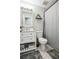 The bathroom features a white vanity with modern finishes, a plant shelf, and neutral color palette at 161 Hunters Chase, Mcdonough, GA 30253