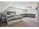 A large, open bedroom features a sitting area with an oversized couch and a calming color palette at 161 Hunters Chase, Mcdonough, GA 30253