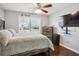 Bedroom with a bed, dresser, TV, and natural light from the window at 161 Hunters Chase, Mcdonough, GA 30253