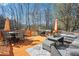 The raised patio features grilling and dining spaces, as well as a comfortable cushioned seating area at 161 Hunters Chase, Mcdonough, GA 30253
