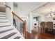 Elegant entryway showcasing hardwood floors, a staircase with iron railings, and a view into the dining area at 161 Hunters Chase, Mcdonough, GA 30253