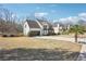 Suburban home with a side-entry garage, surrounded by a green lawn and mature trees, ideal for outdoor living at 161 Hunters Chase, Mcdonough, GA 30253