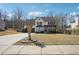 Traditional home with a well-kept lawn, a long driveway, and mature trees, offering a serene suburban setting at 161 Hunters Chase, Mcdonough, GA 30253