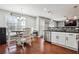Open concept kitchen with stainless steel appliances, black countertops and hardwood floors at 161 Hunters Chase, Mcdonough, GA 30253