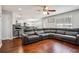 Spacious living area with a large sectional sofa, hardwood floors, and an open view to the kitchen and dining spaces at 161 Hunters Chase, Mcdonough, GA 30253