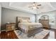 Spacious main bedroom with hardwood floors, a ceiling fan, and a large window at 161 Hunters Chase, Mcdonough, GA 30253