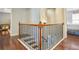 Staircase with hardwood steps and decorative iron railings leading to the second floor at 161 Hunters Chase, Mcdonough, GA 30253