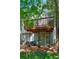Backyard with lower patio area beneath a deck, providing a quaint outdoor space for relaxing and unwinding at 171 Riverview Trl, Roswell, GA 30075