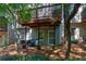 View of backyard with lower patio area beneath the deck, offering a cozy outdoor retreat at 171 Riverview Trl, Roswell, GA 30075