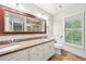 Bathroom with double sinks, large mirror, and plenty of natural light at 171 Riverview Trl, Roswell, GA 30075