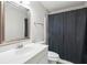 Bathroom featuring a sleek vanity, mirror, and a shower with dark curtain at 171 Riverview Trl, Roswell, GA 30075