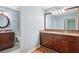 Dual vanity bathroom featuring granite countertops, wood cabinetry, and ample storage at 171 Riverview Trl, Roswell, GA 30075