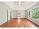 Bedroom features hardwood floors, large windows, and a ceiling fan at 171 Riverview Trl, Roswell, GA 30075