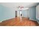 Spacious bedroom featuring hardwood floors, a ceiling fan, and natural light from the windows at 171 Riverview Trl, Roswell, GA 30075