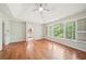 Bedroom features hardwood floors, large windows, and a ceiling fan at 171 Riverview Trl, Roswell, GA 30075