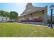 Exterior view of Roswell Junction with grass area, red doors and outdoor seating at 171 Riverview Trl, Roswell, GA 30075