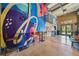Colorful interior space with high ceilings, mural and seating with open doors at 171 Riverview Trl, Roswell, GA 30075