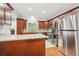 Traditional kitchen with granite countertops, wood cabinets, stainless steel appliances, and wine fridge at 171 Riverview Trl, Roswell, GA 30075