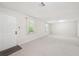 Spacious living room featuring neutral carpeting, windows, and natural light at 171 Riverview Trl, Roswell, GA 30075