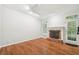 Spacious living room with brick fireplace, hardwood floors, and natural light at 171 Riverview Trl, Roswell, GA 30075