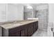 Bathroom featuring a granite countertop with dual undermount sinks and a large tiled shower at 360 Beracah Sw Trl, Atlanta, GA 30331