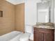 Bathroom with tub-shower combo and single sink with dark wood vanity at 360 Beracah Sw Trl, Atlanta, GA 30331