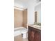 Bathroom features tiled shower-tub, single sink with granite countertop, and dark wood vanity at 360 Beracah Sw Trl, Atlanta, GA 30331