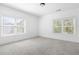 Sunlit bedroom with two large windows overlooking the landscaped yard at 360 Beracah Sw Trl, Atlanta, GA 30331
