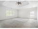 A bright primary bedroom features a tray ceiling, neutral carpet, two windows, and white walls at 360 Beracah Sw Trl, Atlanta, GA 30331