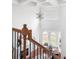The bright foyer showcases a vaulted ceiling, chandelier, and staircase with wood railing and decorative iron spindles at 360 Beracah Sw Trl, Atlanta, GA 30331