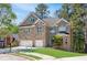 Charming brick home with a two-car garage, lush lawn, and mature trees in a lovely neighborhood at 360 Beracah Sw Trl, Atlanta, GA 30331