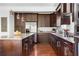 A kitchen features granite counters, wood cabinets, stainless appliances and a kitchen island with pendant lights at 360 Beracah Sw Trl, Atlanta, GA 30331