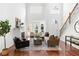 Bright living room features high ceilings, large windows, a fireplace, and stylish modern furniture at 360 Beracah Sw Trl, Atlanta, GA 30331